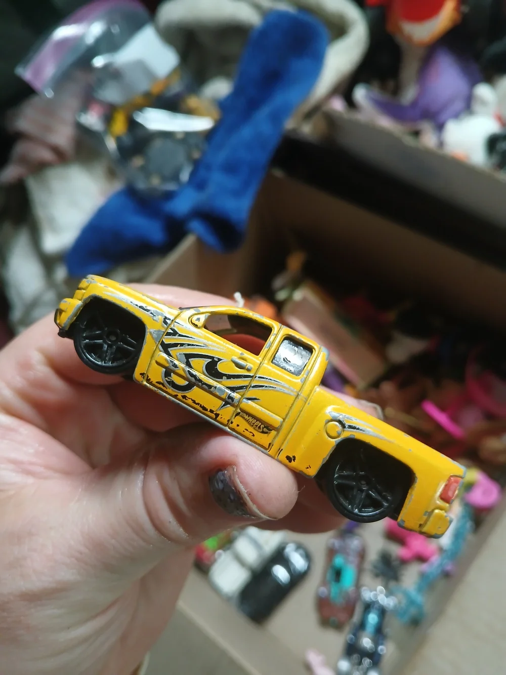 yellow 1:64 scale Hot Wheels Chevy Silverado,